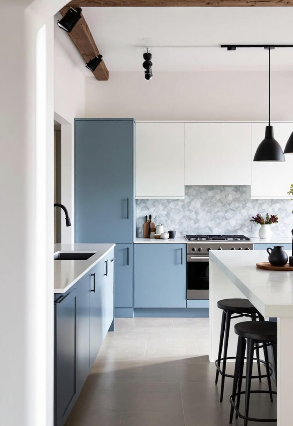 Contemporary kitchen with powder blue and white cabinets, marble-look quartz counters, geometric tile backsplash and minimalist black pendant lights, shot in late afternoon industrial lighting