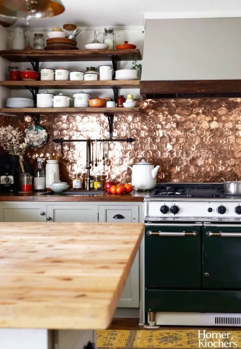 Vintage kitchen with antique butcher block island, enamelware collection on reclaimed wood shelves, copper backsplash, and pull-out spice racks next to a restored vintage range.