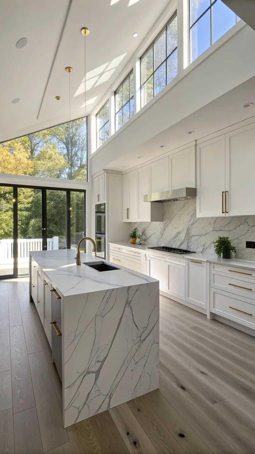 Modern minimalist kitchen with 10-foot ceilings, floor-to-ceiling windows, white cabinets, marble-look backsplash, quartz countertop island, brushed gold fixtures, and wide-plank white oak floors